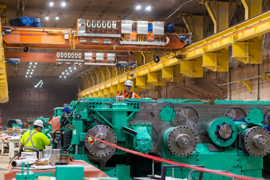 Miner assembly team working on the sixth 4-rotor mining machine preparing it for commissioning 
